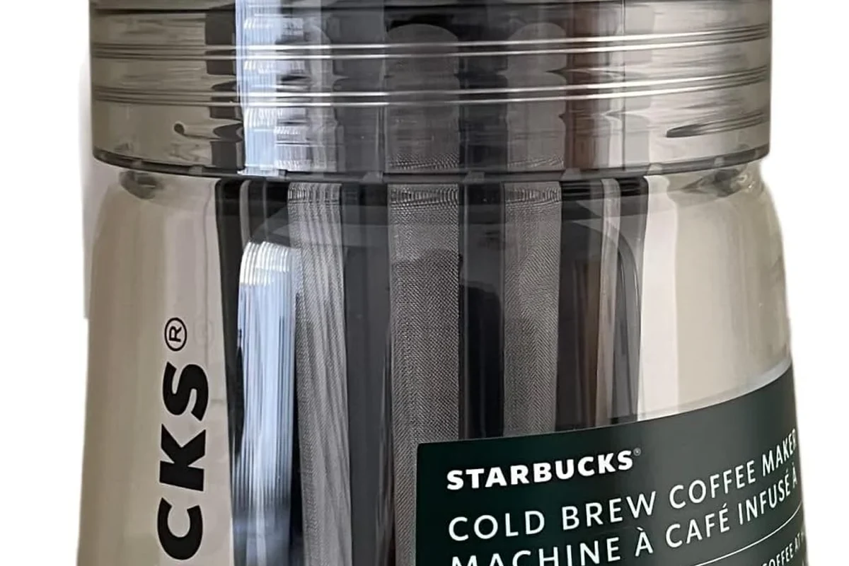 Starbucks cold brew coffee maker with ground coffee, water, and a finished glass of iced cold brew